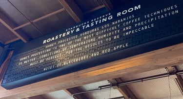 a Solari board at the Starbucks reserve roastery advertising coffee