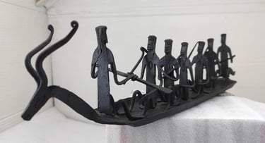 "Traditional Bastar forged iron boat with seven figures and deer head – left side view-Meant for export"