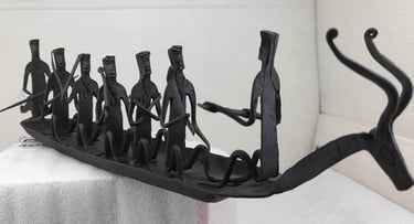 "Bastar tribal iron sculpture featuring deer-head boat and seated villagers – right view-Designed for export"