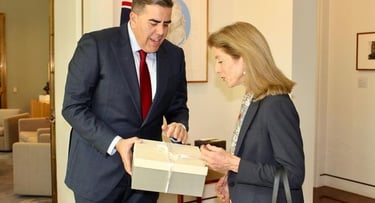 2 people one person handing a box to the other person