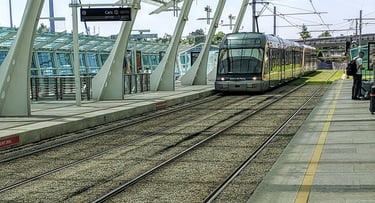 Metro train arriving at Porto Airport station with passengers boarding, showcasing the station platf