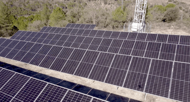 solar panels with a tower in the background