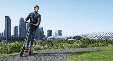 a man riding a scooter in a city