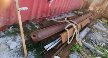 a pile of metal pipes and pipes in a yard scrap by swastik exim team