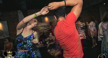a man and woman dancing at a party