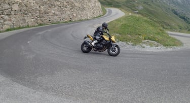 a person riding a motorcycle on a winding road