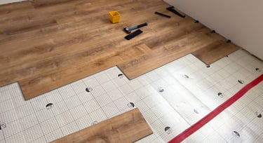 Plank flooring layed over waterproofing underlayment pad.