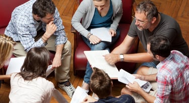 a group of people sitting around a table