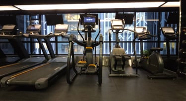 a gym room with a lot of exercise equipment
