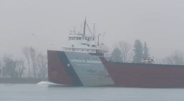 Close-up of the forward pilothouse of classic freighter Arthur M. Anderson passing in the fog.