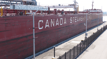 A Large red ship in Lock 3. White lettering says, "CANADA STEAMSHIP LINES".
