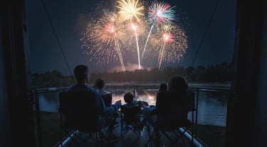 a family watching fireworks in the night sky on an RV deck