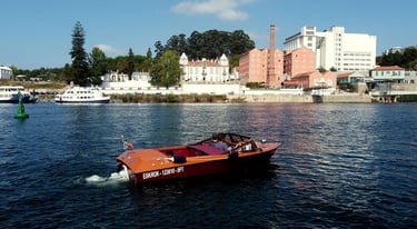 Private wooden speedboat cruising on the Douro River in Porto