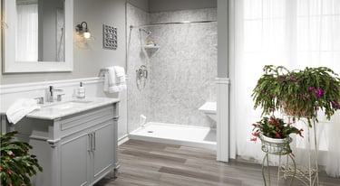 Walk-in shower with gray marble walls and vanity installed by Toledo New Bath.