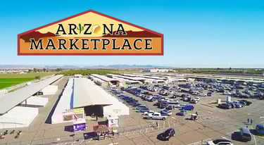 Aerial view of the Arizona Marketplace outdoor flea market with rows of vendors and a large parking lot.
