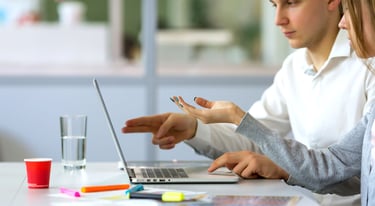 Male and Female Website Designers with Laptop