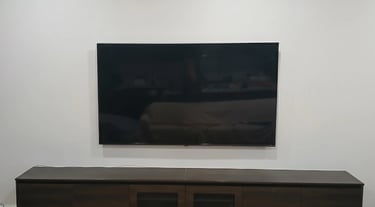 Space-saving ultra slim TV wall mounting for a compact apartment living room in Melbourne CBD.