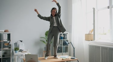 A person dancing as an exercise snack during a workday break.