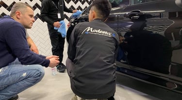 a man is sitting on the ground while another man is standing next to him