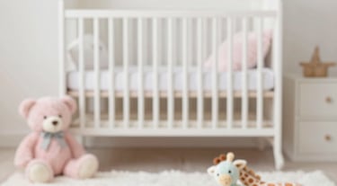 Beautiful Baby Nursery with regal white ornate crib in center.  Fancy white wall paper, white rug
