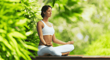 a woman meditating outdoors