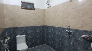 Bathroom at hotel rudra near jolly grant airport