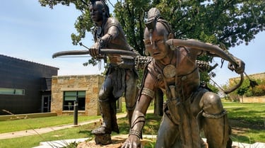 a statue of a man and a woman with bow