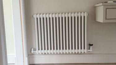 a white radiator on a wall installed by PBP Services in Evesham