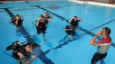a group of scuba divers in a pool