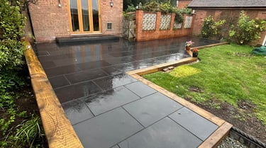 Outdoor living area with paving and fencing in Pershore