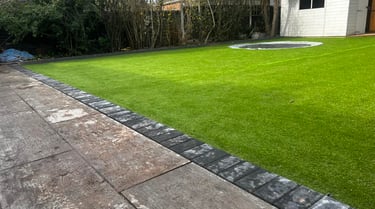 Modern garden design with patio, turf, and fencing in Worcester
