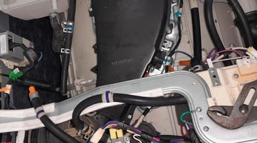 LG washer dryer combo internal view showing heater inspection during DHE error diagnosis – hoses, wi