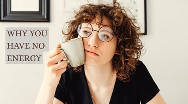 Woman looking tired while holding a coffee mug, representing low energy and daytime fatigue in women