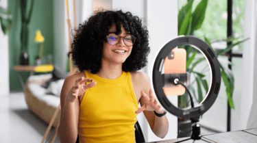 an influencer smiling in front of ring light