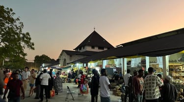 Darajani Market in Stone Town Zanzibar during the evening with locals shopping for spices, fruits, and fresh seafood