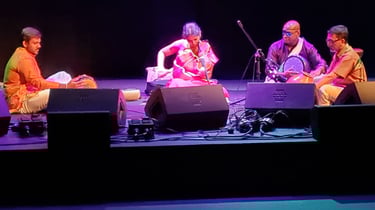 A picture of artists performing in an auditorium
