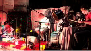 A picture of artists in violin, drums and guitar