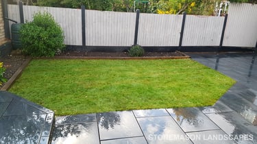 Grey sandstone circle paving slabs with charcoal edging