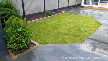 Grey sandstone circle paving slabs with charcoal edging