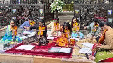 A picture of Srividya Venkat and students performing