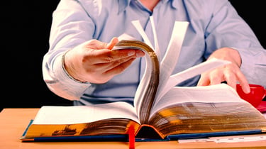 Historical paranormal researcher studying old records and hauntings connected to spiritual activity