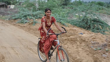 A lady cycling past our hotel, the Gulaab Niiwaas Palace,  Pushkar , Rajasthan, India