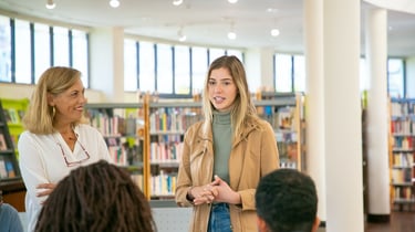 a woman in a library with a man and woman