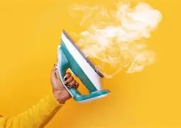 an iron shooing out steam