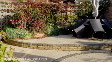 Fully paved multi-tier level garden with elevated raiesed patios and circles.