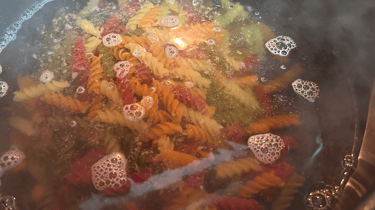 Colored veggie noodles in water