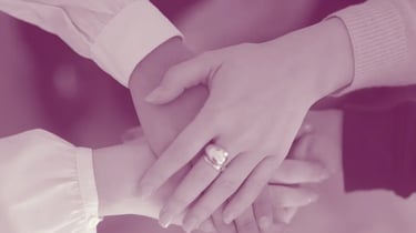 Women holding hands together for Trust