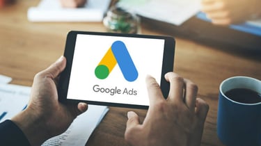 a person holding a tablet with google ads