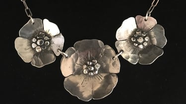 silver necklace with hand formed flowers
