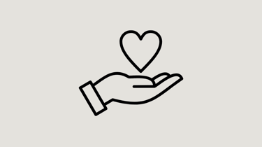 a hand holding a heart shaped object